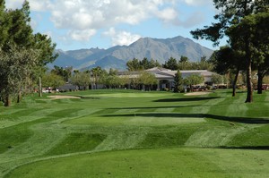 Golf course fairway with clubhouse and mountains